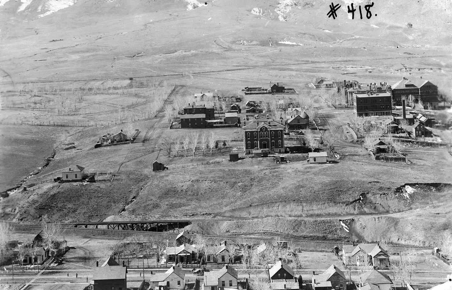 Black-and-white aerial photograph of a small mountain town.